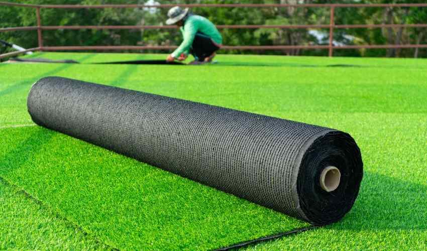 Rolling Out Artificial Turf On Side