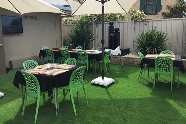 Outdoor dining area with artificial grass