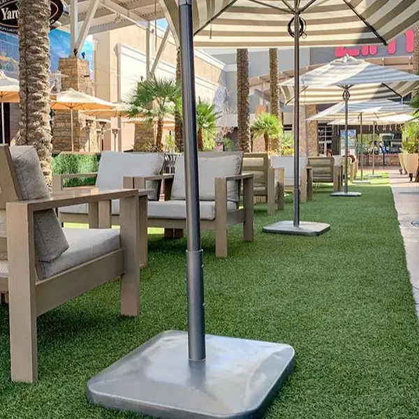 Restaurant Artificial Grass fitting showing precise turf cuts around tables and walkway spaces