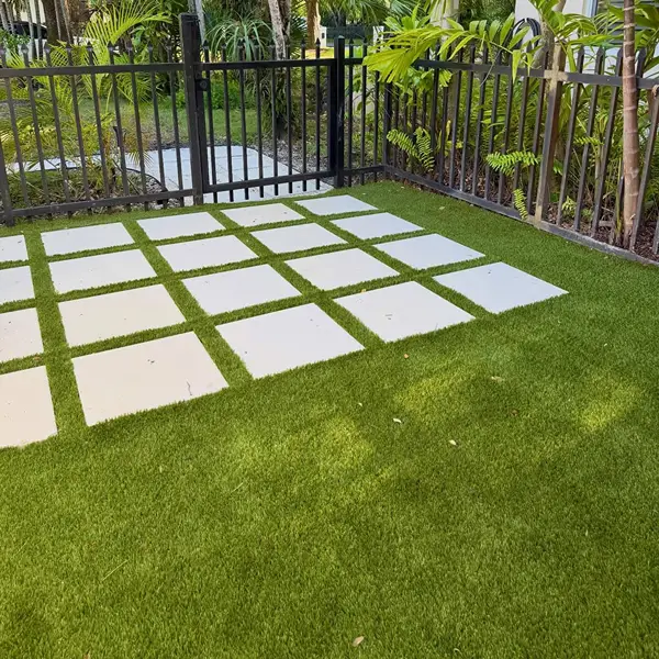 Artificial grass with stepping stone pathway in Al Quoz garden